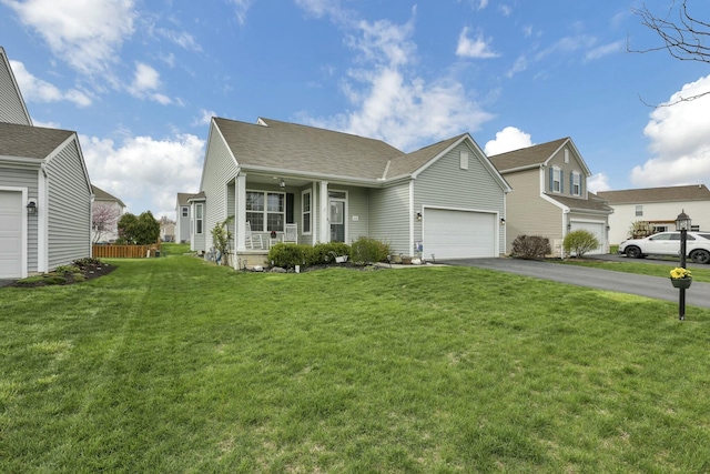 114 Hummock Dr, Etna, OH 43062 - view of front of home featuring a porch, an attached garage, a front lawn, and aphalt driveway