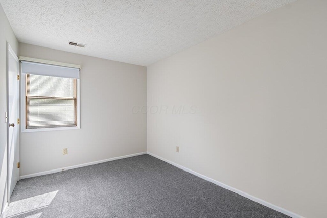 empty room with baseboards, carpet floors, and a textured ceiling