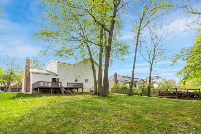 back of property with a deck, a chimney, and stairway