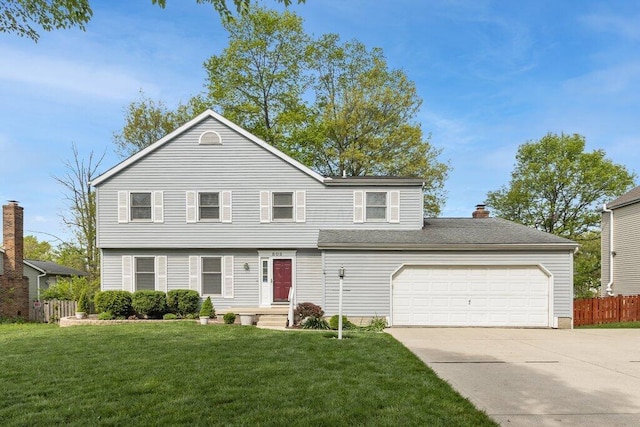 view of front facade with concrete driveway, a chimney, and an attached garage