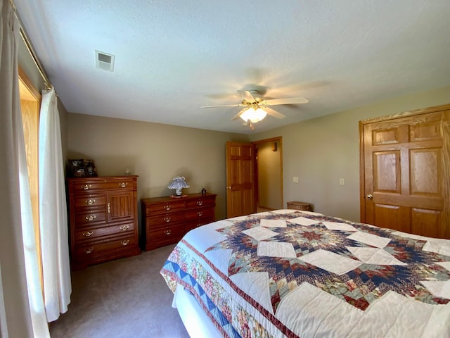 bedroom featuring carpet floors, visible vents, and ceiling fan