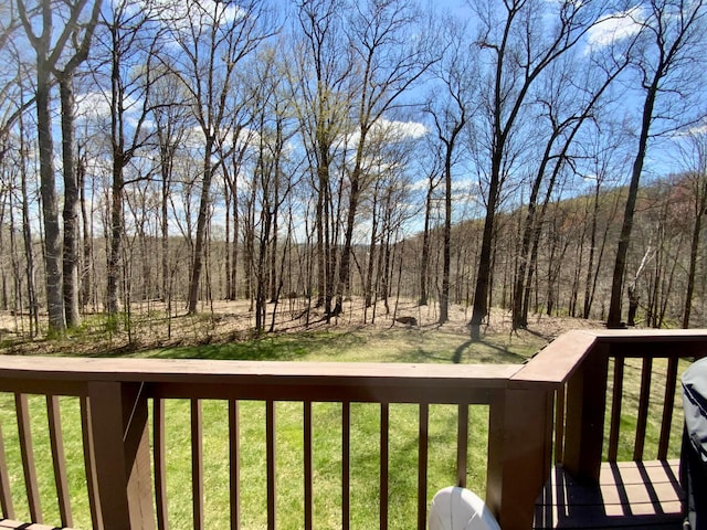 wooden deck featuring a lawn