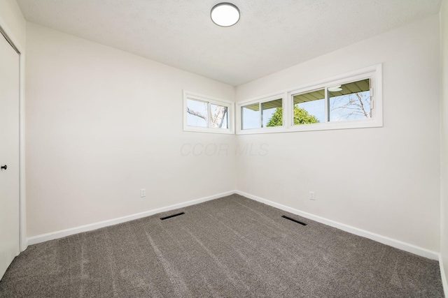 carpeted empty room with baseboards and visible vents