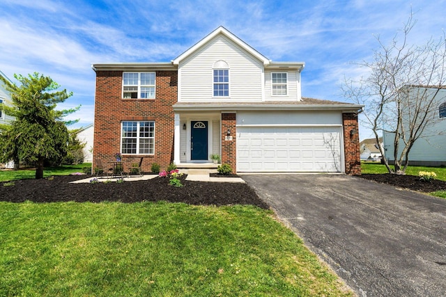 traditional-style home with brick siding, a front lawn, aphalt driveway, and a garage
