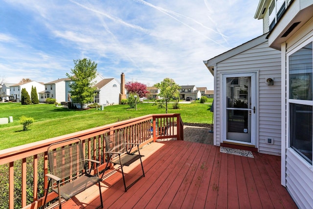 deck featuring a lawn and a residential view