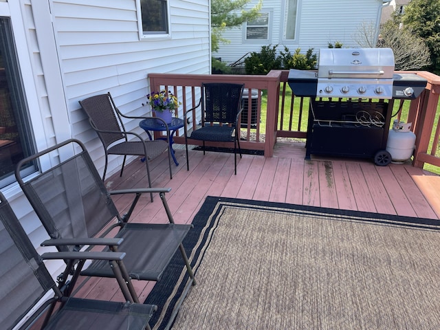wooden deck with a grill