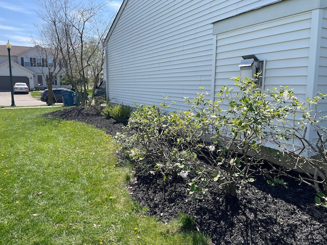 view of property exterior with a lawn