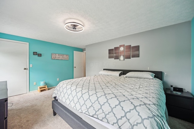 bedroom featuring carpet flooring and a textured ceiling