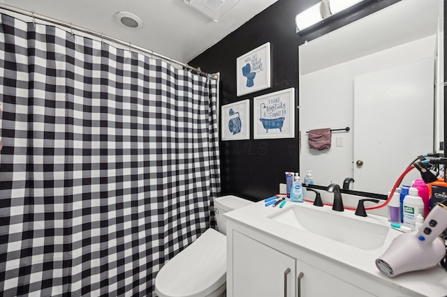 full bath featuring toilet, a shower with shower curtain, and vanity