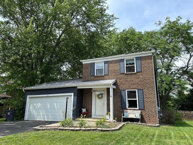 604 Forestwood Dr, Gahanna, OH 43230 - traditional-style house featuring an attached garage, asphalt driveway, and brick siding