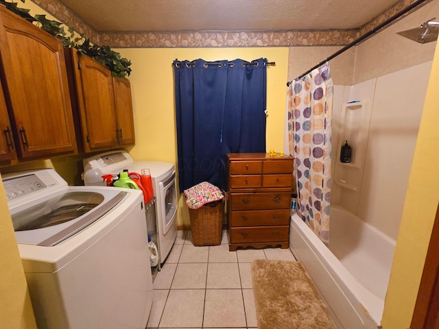 laundry area featuring washing machine and clothes dryer, laundry area, and light tile patterned flooring