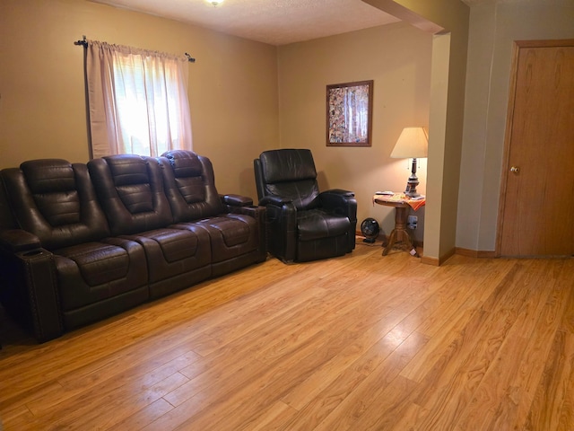 living area with light wood finished floors and baseboards