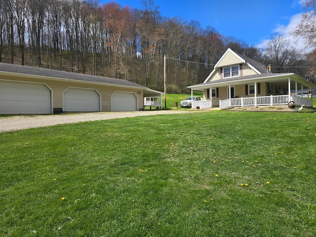 farmhouse inspired home featuring a front lawn, driveway, a porch, and a garage