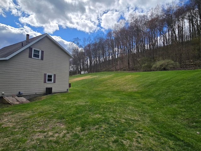 view of home's exterior with central AC and a lawn