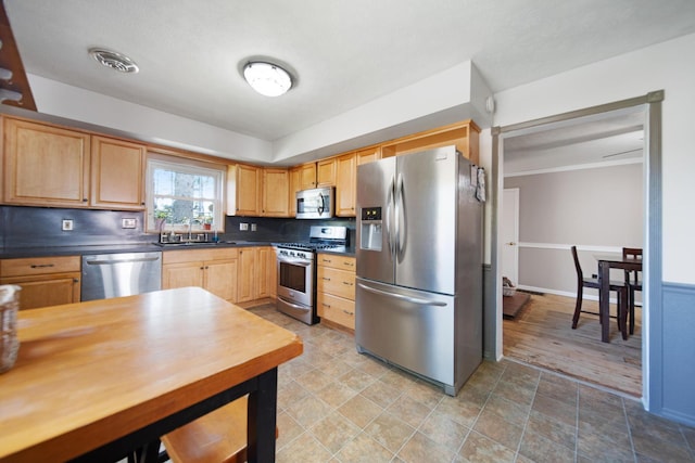 49 Front St, Orient, OH 43146 - kitchen featuring light brown cabinetry, appliances with stainless steel finishes, dark countertops, and a sink