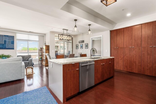 kitchen featuring a center island with sink, dark wood finished floors, dishwasher, a sink, and open floor plan