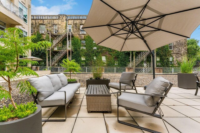 view of patio / terrace featuring an outdoor hangout area, fence, and stairway