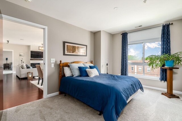 carpeted bedroom with baseboards and visible vents