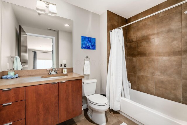 bathroom with vanity, toilet, tile patterned floors, shower / bathtub combination with curtain, and visible vents