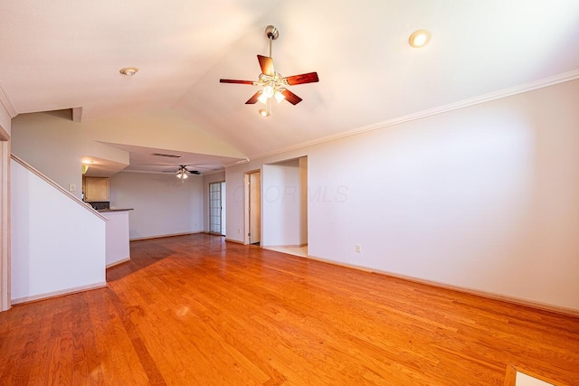 unfurnished living room featuring vaulted ceiling, light wood-type flooring, a ceiling fan, and ornamental molding