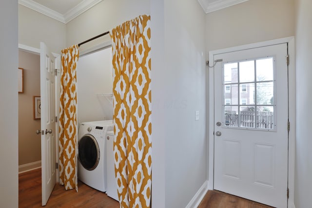 laundry room featuring ornamental molding, washer / clothes dryer, wood finished floors, and laundry area