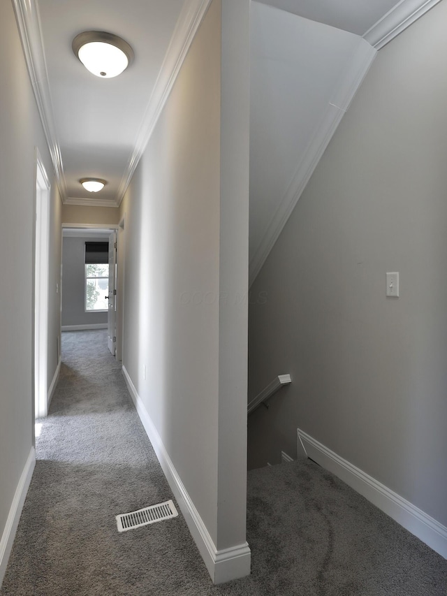 hall with ornamental molding, visible vents, carpet floors, an upstairs landing, and baseboards