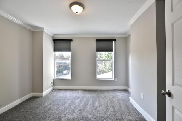 carpeted spare room with baseboards and ornamental molding