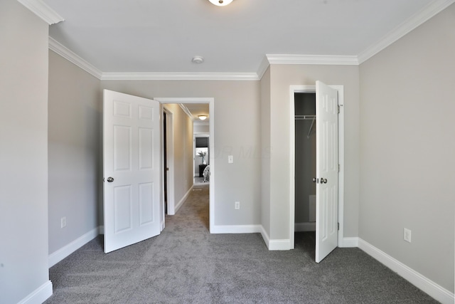 unfurnished bedroom featuring baseboards, crown molding, and dark colored carpet