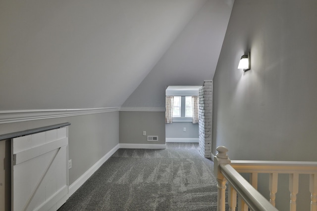 additional living space featuring carpet floors, lofted ceiling, visible vents, and baseboards