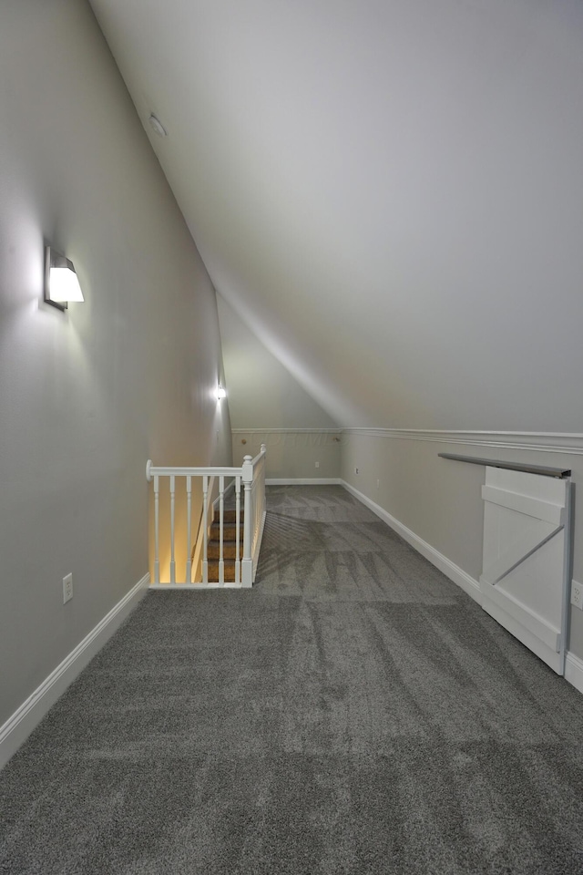 bonus room with vaulted ceiling, baseboards, and carpet