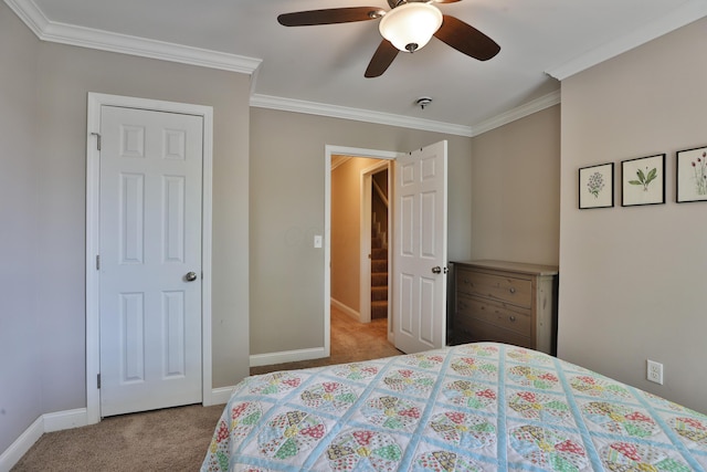 bedroom with crown molding, carpet flooring, and baseboards