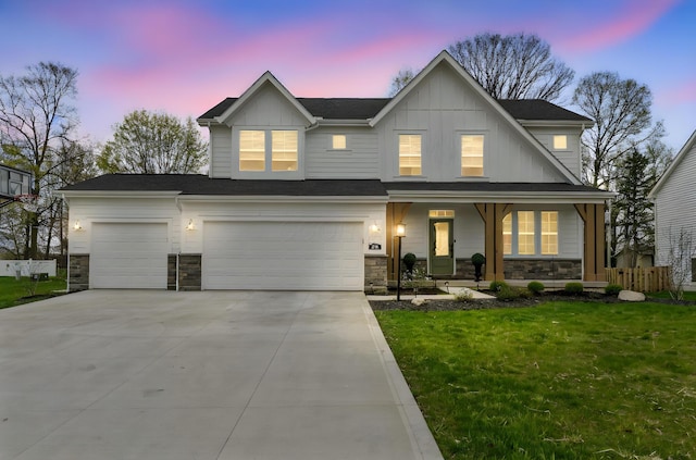 view of front of home with board and batten siding, a front yard, covered porch, and stone siding
