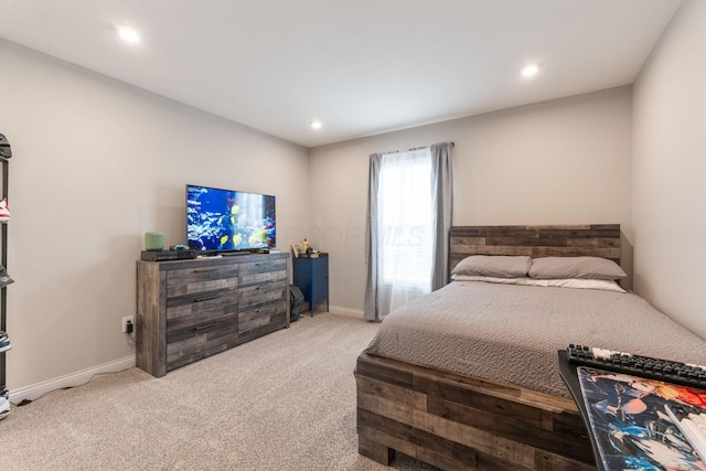 carpeted bedroom featuring baseboards and recessed lighting