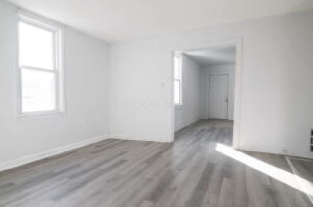 404 Sherman Ave, Springfield, OH 45503 - unfurnished room featuring wood finished floors, healthy amount of natural light, and baseboards