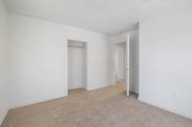 404 Sherman Ave, Springfield, OH 45503 - unfurnished bedroom with light colored carpet and a closet