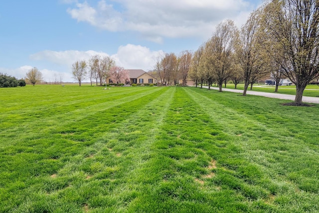 view of property's community with a lawn and a rural view