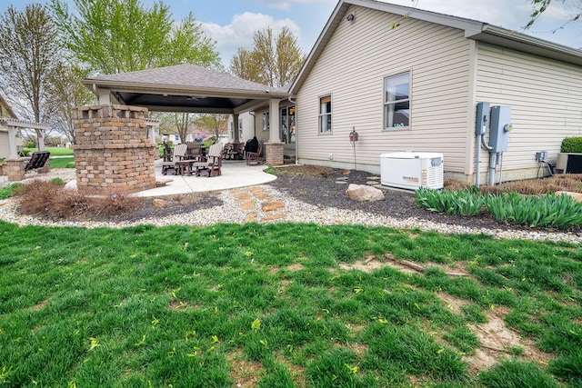 back of property with a gazebo, a yard, cooling unit, and a patio