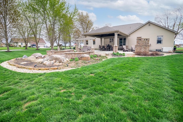 back of house with a yard and a patio area