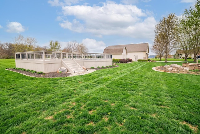 back of house with a lawn, a wooden deck, and stairs