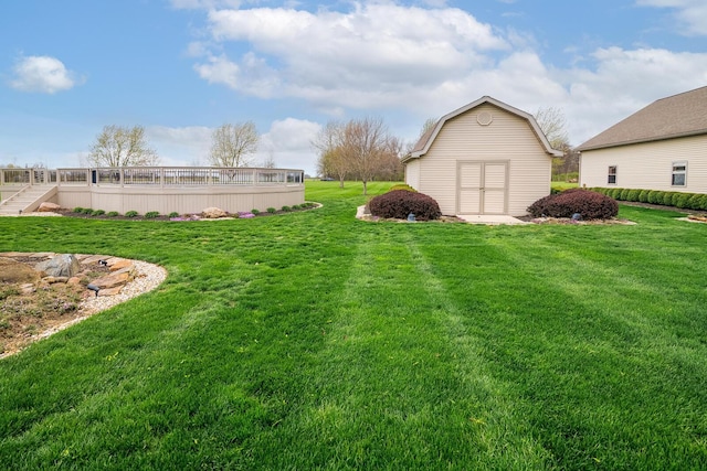 view of yard featuring an outdoor structure and a deck