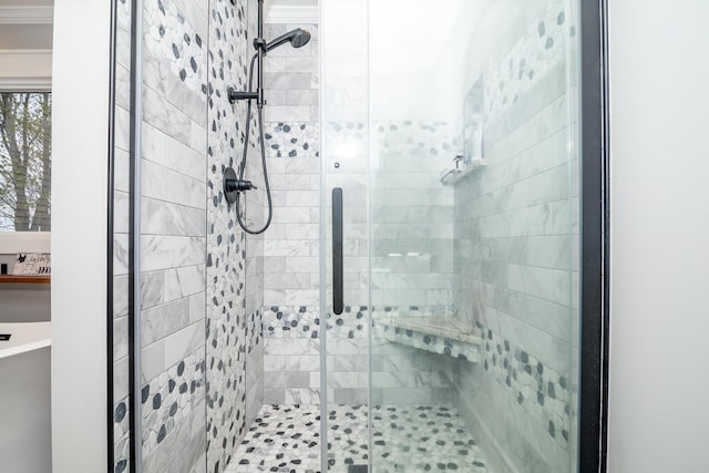 full bath with a stall shower and ornamental molding