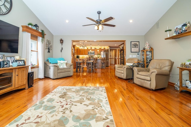 living room with vaulted ceiling, a ceiling fan, light wood finished floors, visible vents, and recessed lighting