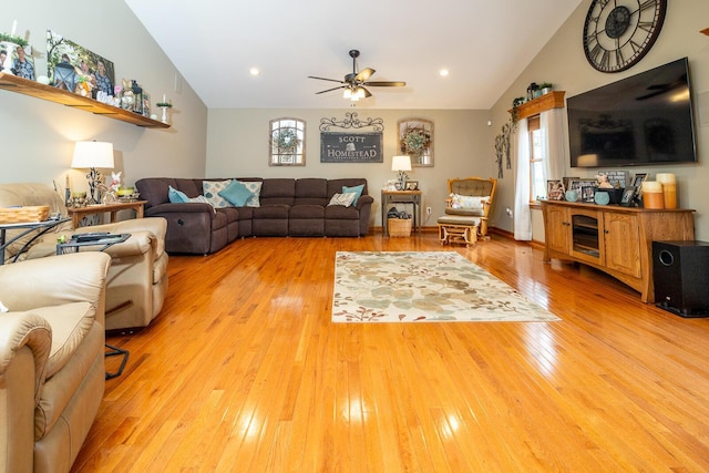 living area with light wood-type flooring, plenty of natural light, vaulted ceiling, and a ceiling fan