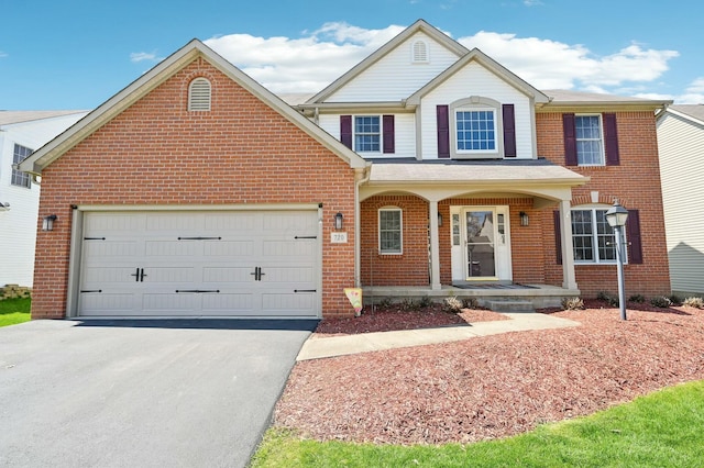 traditional home featuring an attached garage, brick siding, driveway, and covered porch