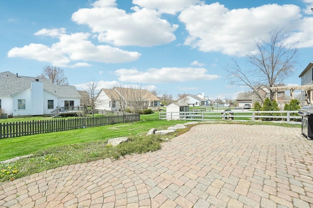 view of patio / terrace with a residential view and fence