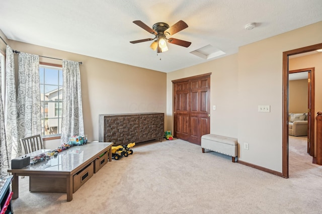 sitting room with baseboards, a ceiling fan, and carpet flooring