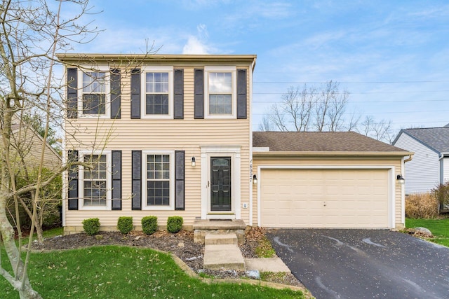 view of front of home with a garage and aphalt driveway