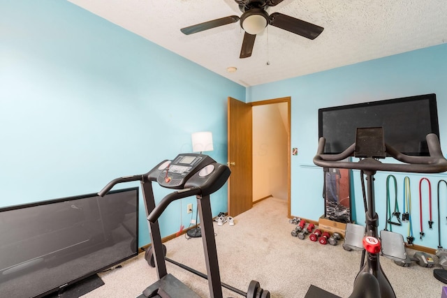 workout area featuring carpet floors, a textured ceiling, and ceiling fan