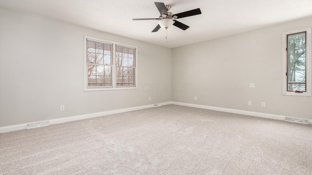 unfurnished room with visible vents, baseboards, carpet floors, and ceiling fan