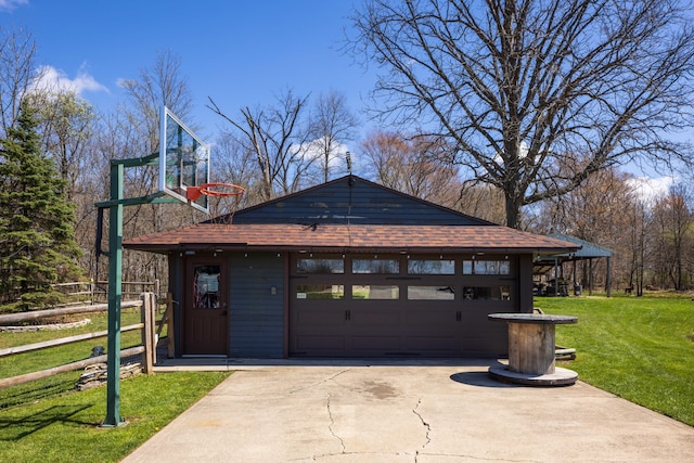 9704 Loudon St, Johnstown, OH 43031 - view of front facade with fence, a shingled roof, an outbuilding, a front yard, and a garage